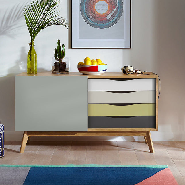 Modern oak sideboard with colorful drawer design in a room setting