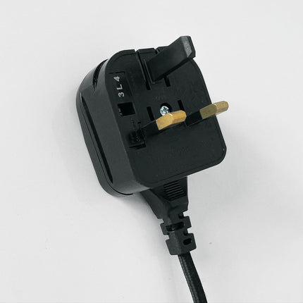 Black plug with a visible cord on a white background