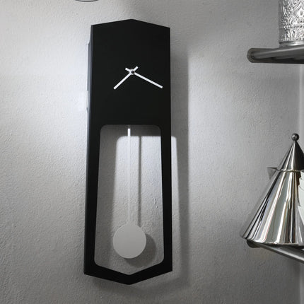 Modern black wall clock with pendulum design on a gray wall