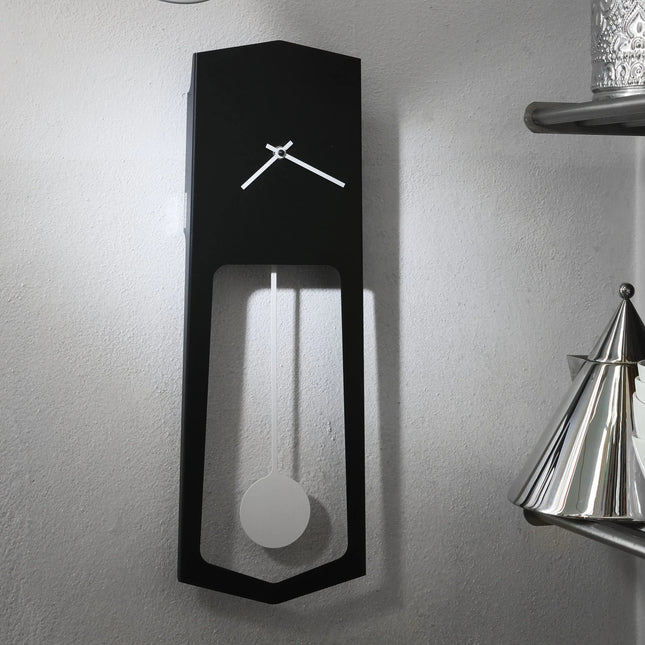 Modern black wall clock with pendulum design on a gray wall