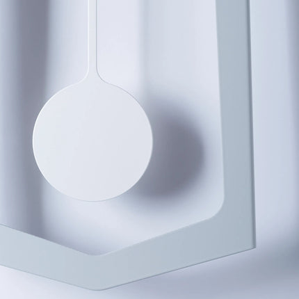 Close-up of a white pendulum wall clock