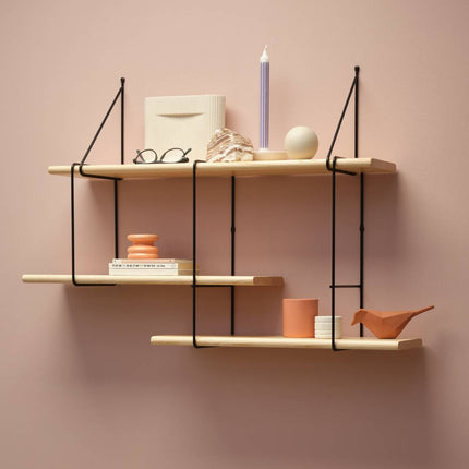 solid wooden ash shelf in a natural finish hanging on a wall with decorative items displayed on shelf