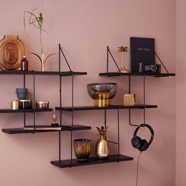 close up detail image of the solid wood shelf painted in black with ornaments displayed on shelf