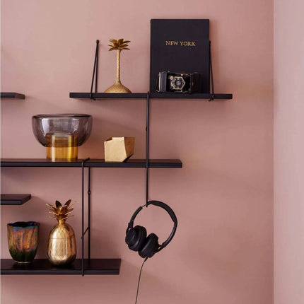 close up detail image of the solid wood shelf painted in black with ornaments displayed on shelf in black colour