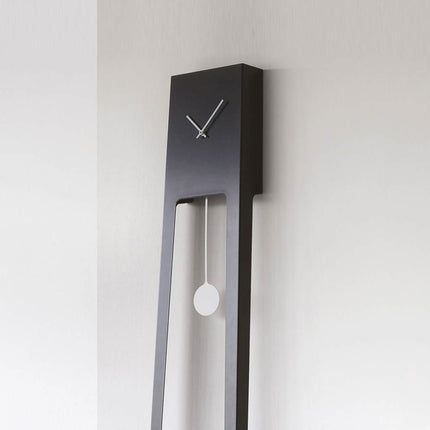 Tiuku Modern wall clock in black finish with long pendulum on a light gray background