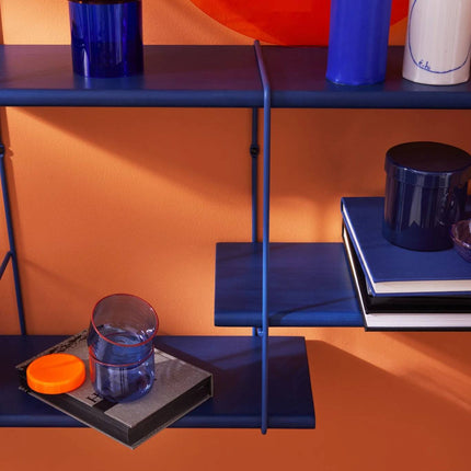 close up detail image of the solid wood shelf painted in blue with ornaments displayed on shelf in the same colour