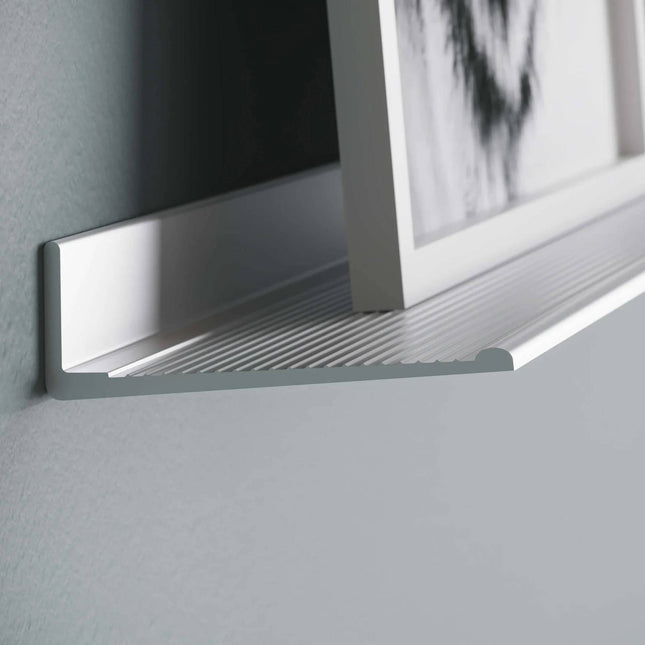 Aluminium metal frame shelf with a framed picture in the background