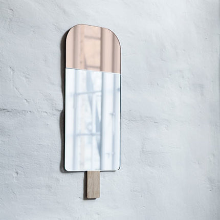 pink ice cream mirror hanging on a wall