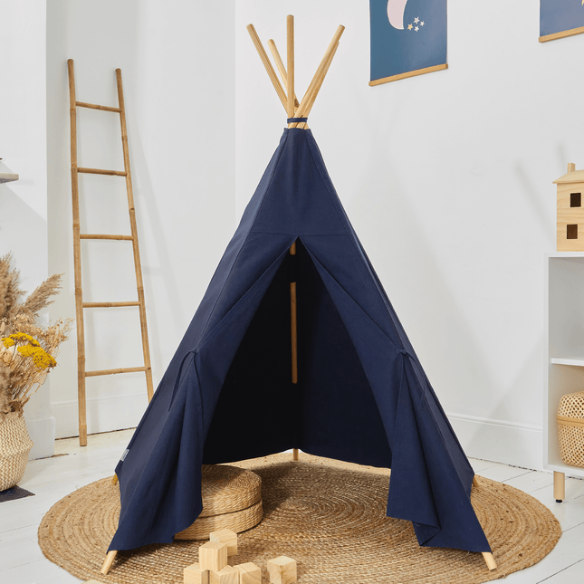Navy blue teepee tent in a room with a wooden ladder and decor items.