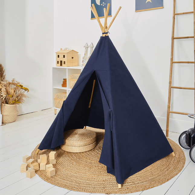 Navy blue teepee tent in a room with wooden blocks and a ladder.