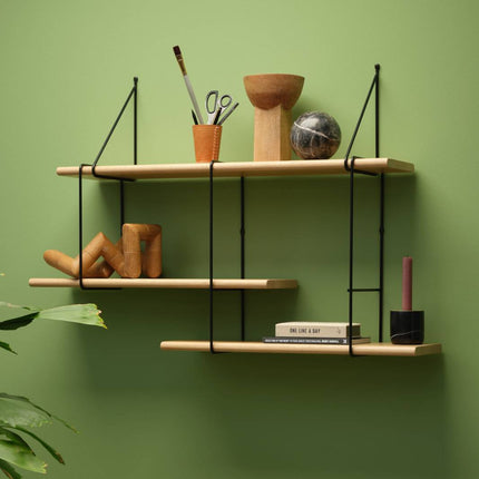 solid wooden oak shelf in a natural finish hanging on a wall with decorative items displayed on shelf