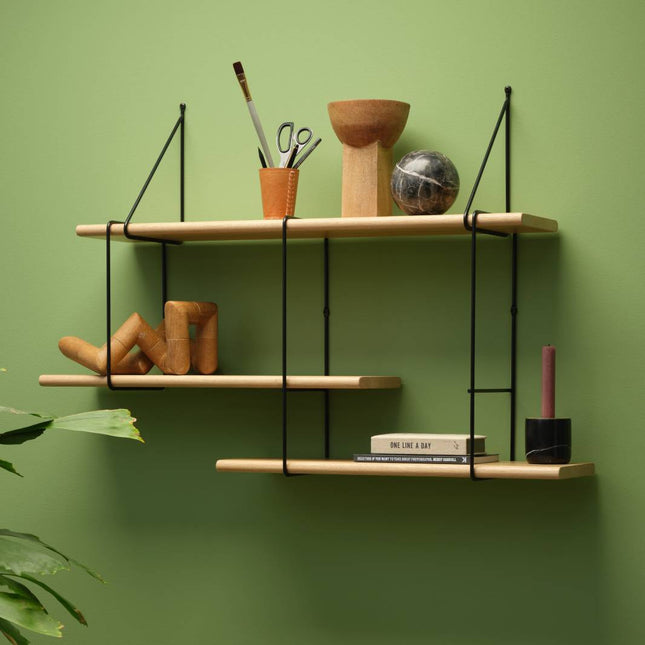 solid wooden oak shelf in a natural finish hanging on a wall with decorative items displayed on shelf