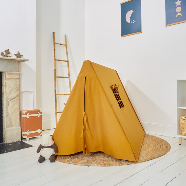Yellow children's tent in a room with a ladder and toys