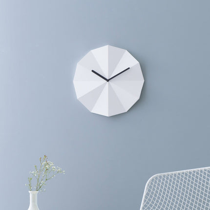 white oak wall clock hanging on a blue wall