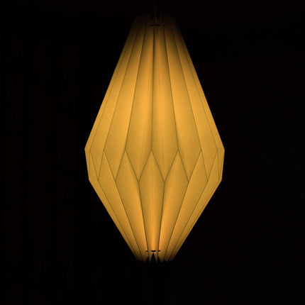origami lamp shade in the dark with light on 