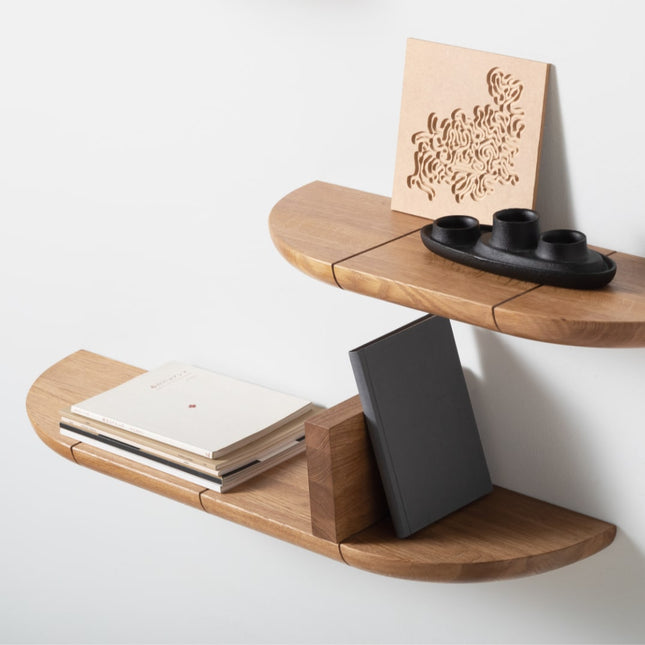 Solid oak wooden wall shelf with various items on a white background