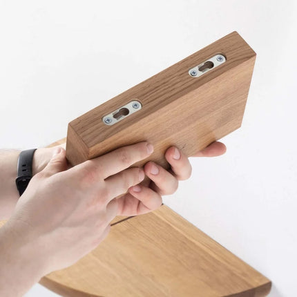 hand holding a paragraph wooden shelf on a white background