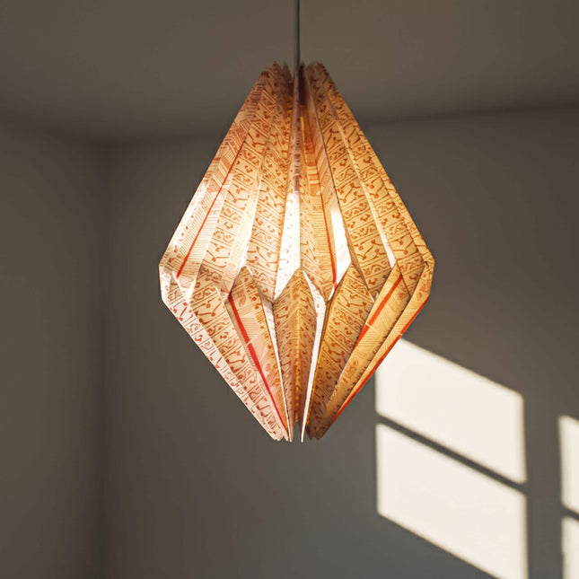 red patterned origami lampshade hanging with light on