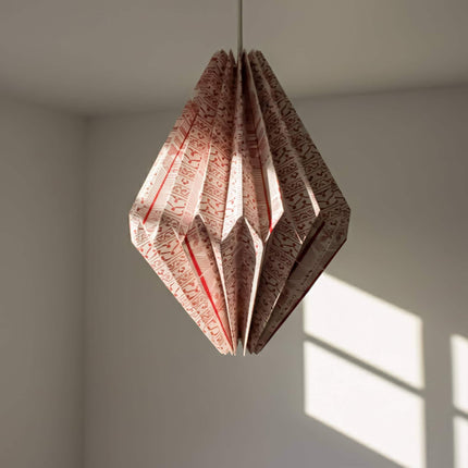 red origami lampshade hanging with light off