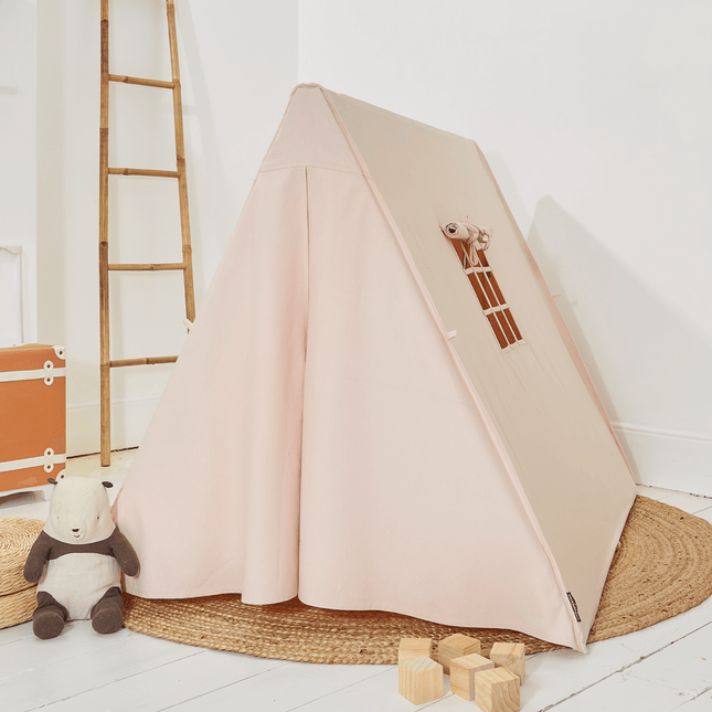 Pink children's tent with a ladder in a room with a wooden floor and a ladder.