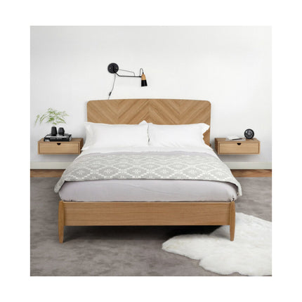 Wooden wall mounted side tables with white bedding in a minimalistic bedroom setting.