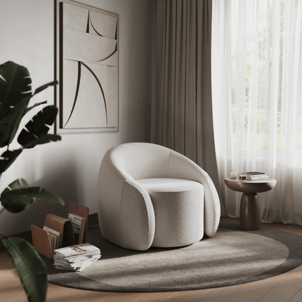 Modern beige armchair in a stylish living room with a plant and side table.