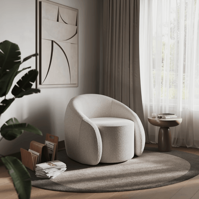 Modern beige armchair in a stylish living room with a plant and side table.
