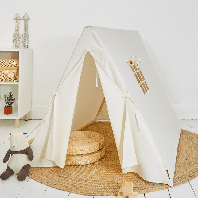 White children's play tent with wooden accents on a white floor and play mat