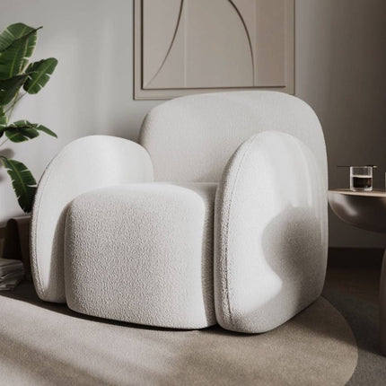 Modern white armchair in a stylish room with decor elements.